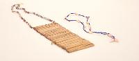 Untitled (bamboo breast adornment and cowry shell necklace)