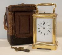 Brass clock, key, and case