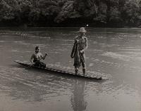 Untitled (Iban man and woman in a dug-out canoe on a river)